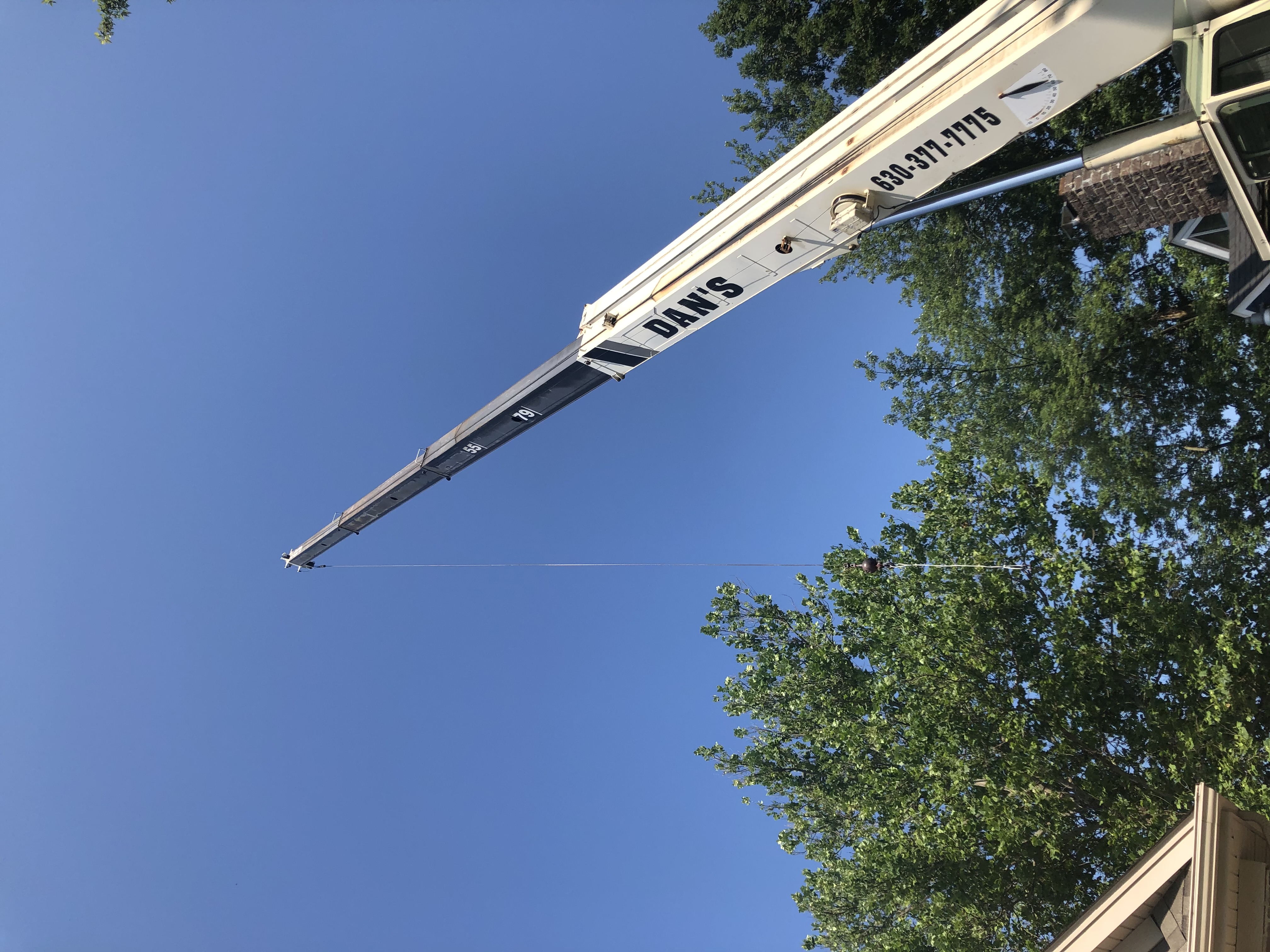 Heavy equipment handling large timber slab